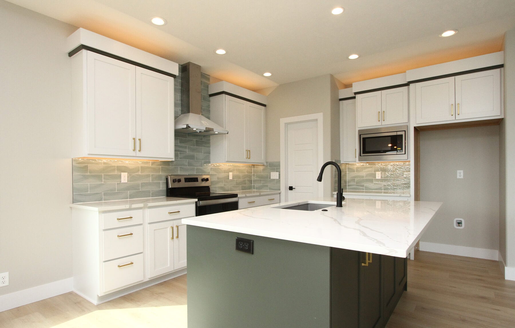 Luxury spec home kitchen with white cabinetry and granite countertops