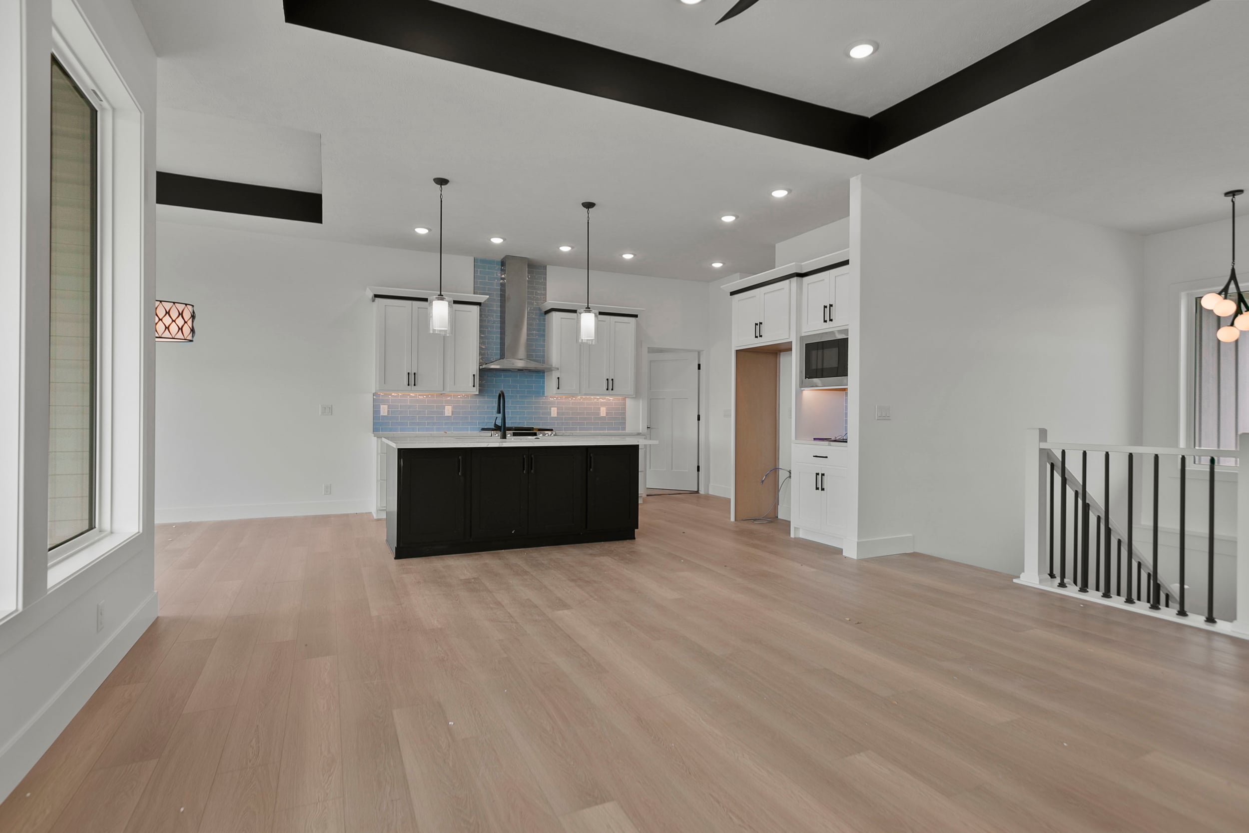 Open-concept custom kitchen with wooden island and warm hardwood floors